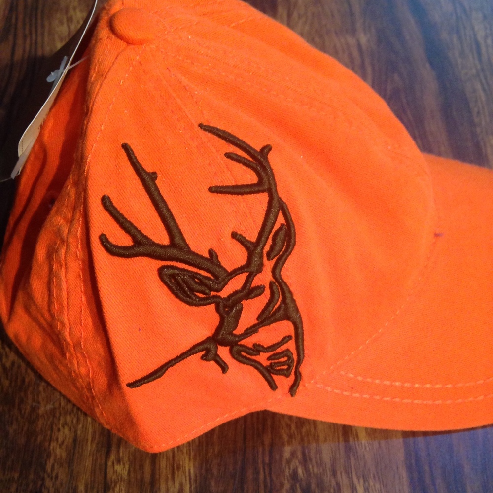 Orange hat with a brown embroidered deer.